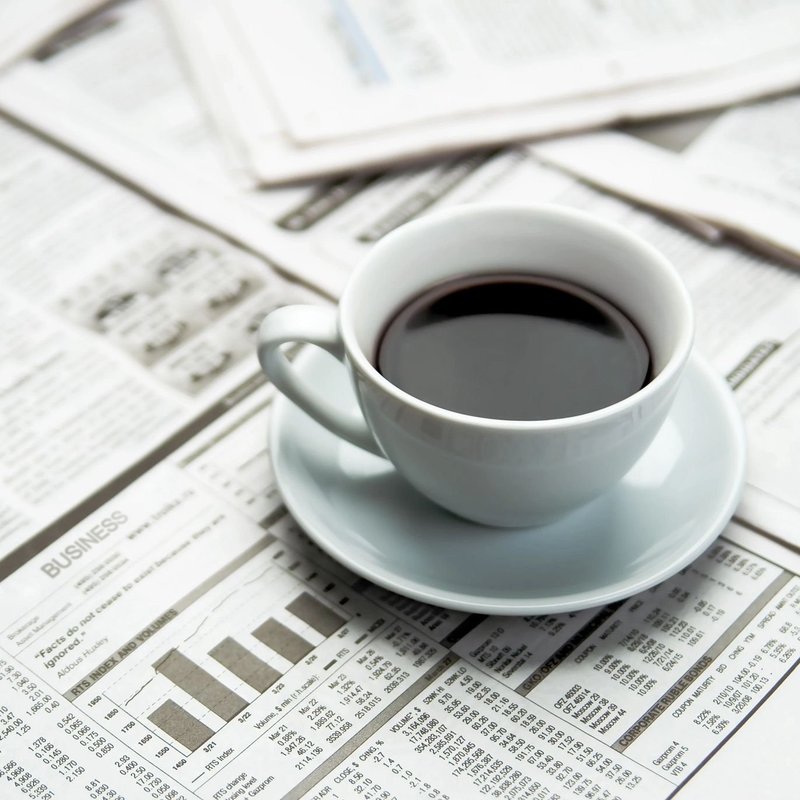 Coffee cup on a pile of graph documents