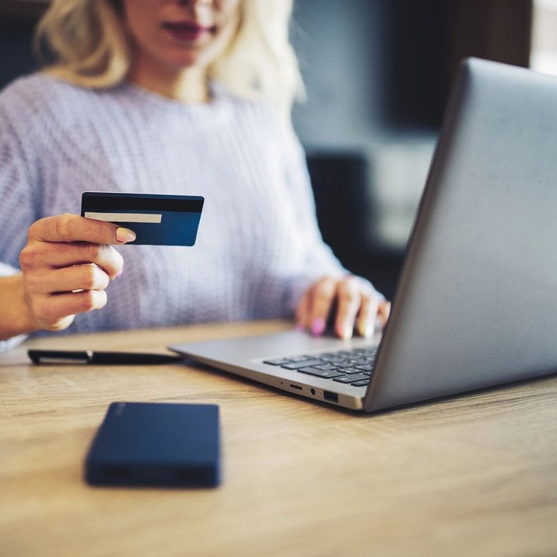 Woman Accessing Online Financing services for Maximum Carpets &Flooring in Lynbrook, NY
